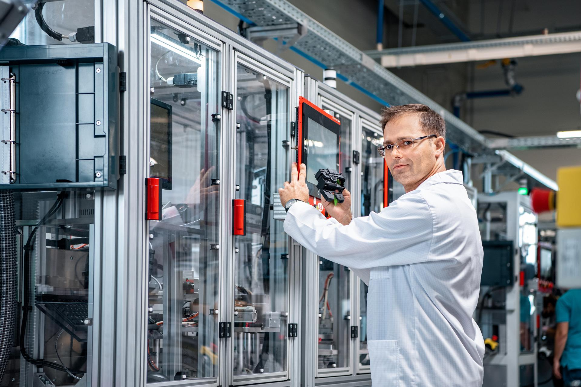 Specialist beside industrial automation equipment